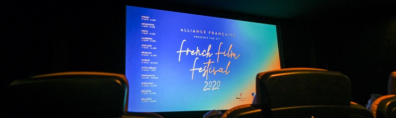 Movie theatre screen showing Alliance Francaise French Film Festival
