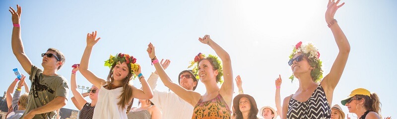 People dancing and having fun with flower crowns.